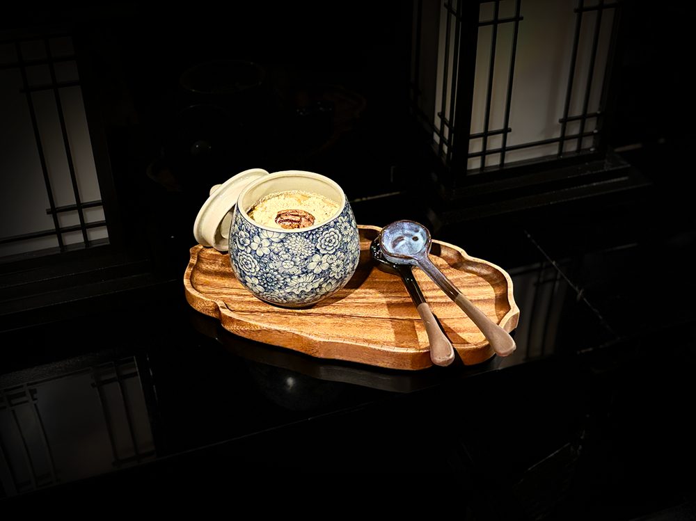 Mixed Grain Makgeolli Tiramisu — served in a blue-and-white porcelain pot with roasted grain powder